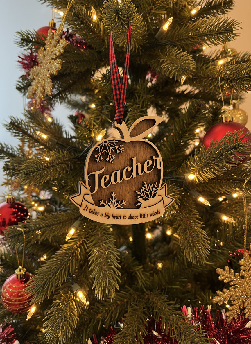 Wooden 'Teacher' ornament on a decorated Christmas tree with lights and ornaments.